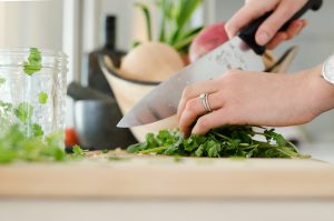 Dietary changes. Hand chopping vegetables and herbs