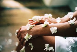 Arms and hands with white flowers