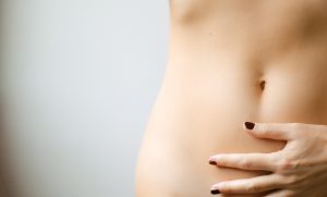 About probiotics - woman placing hand on abdomen