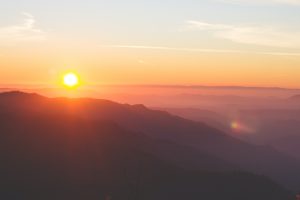 Sun rising behind mountains in the morning.