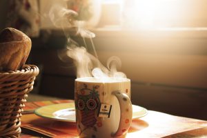 Cup of tea on a kitchen table in morning light. 