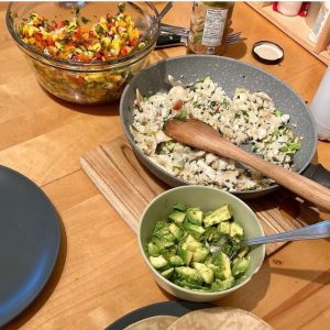 assembly of bowls with ingredients to make fish tacos with mango salsa