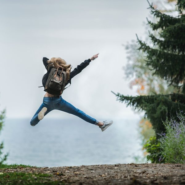 girl jumping in a forest