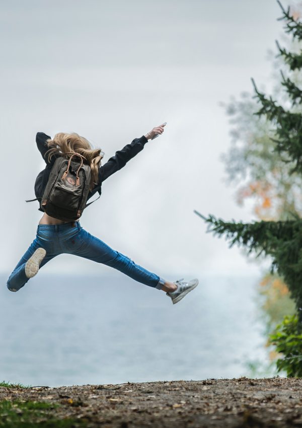 girl jumping in a forest