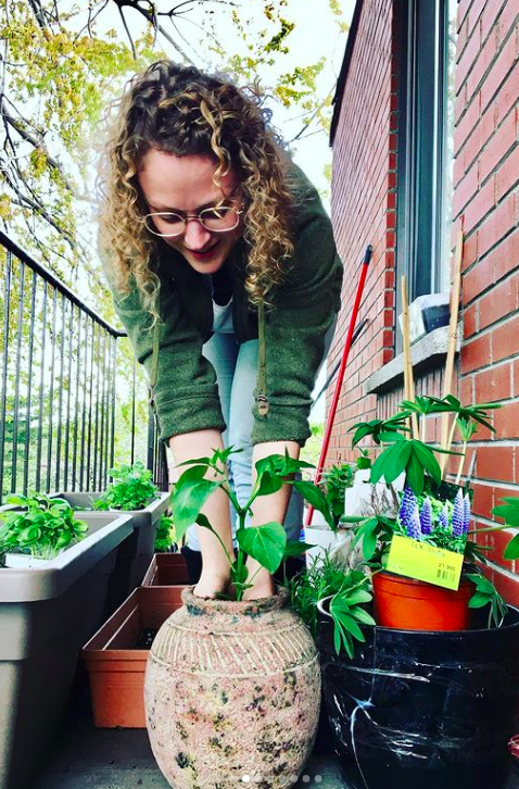 Girl potting plants on a balcony, subject is balcony gardening.