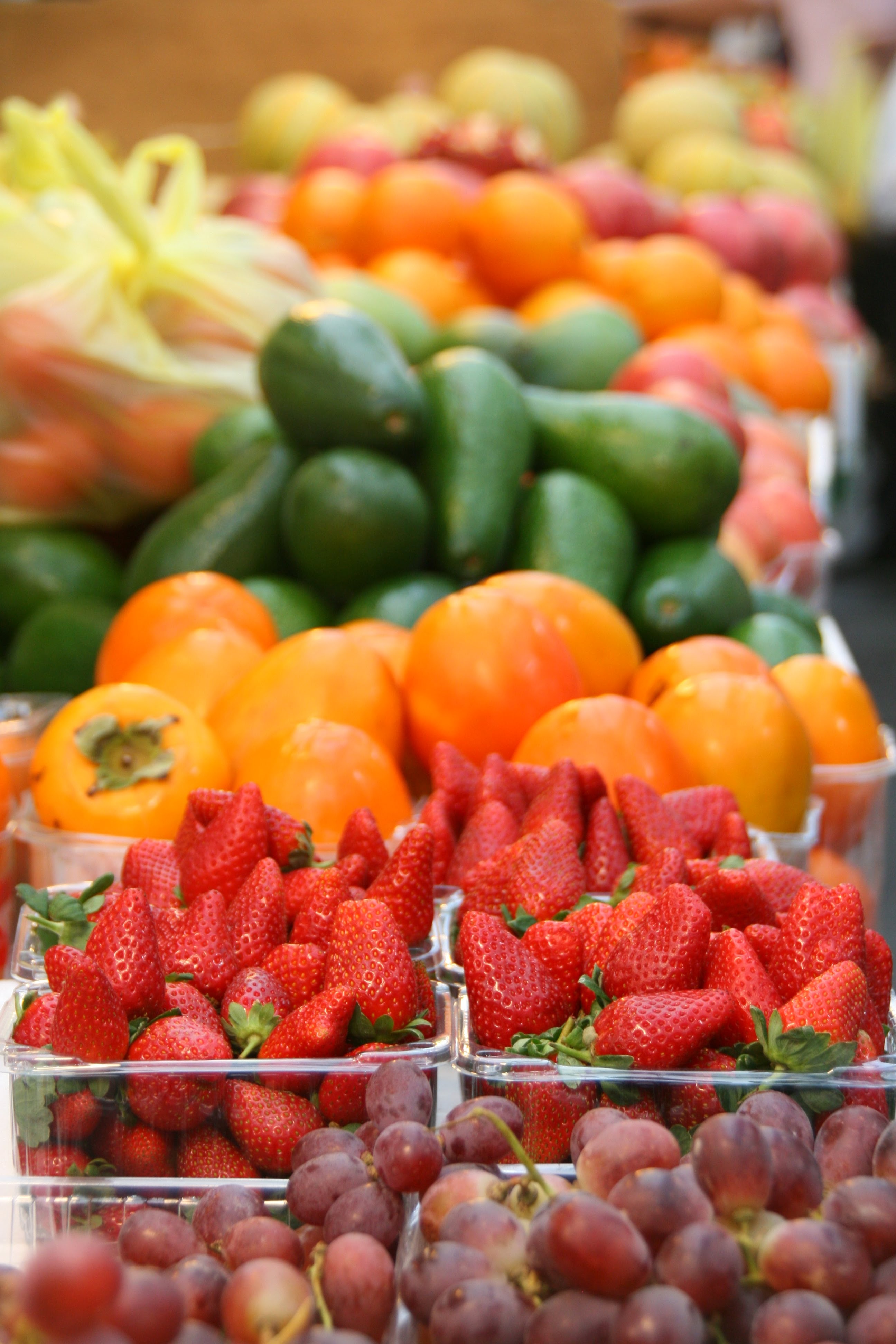 vertical image of an assortment of colourful fruits and vegetables 